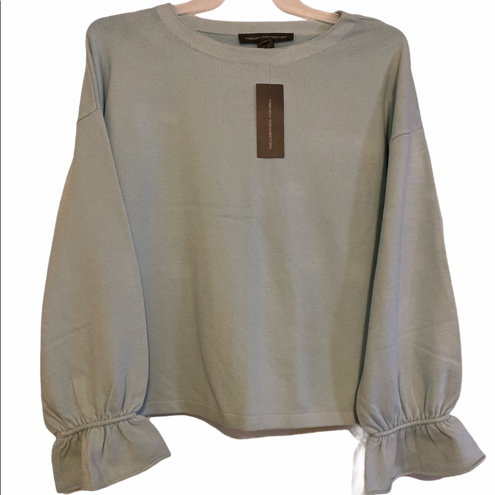 Woman’s light blue sweater.